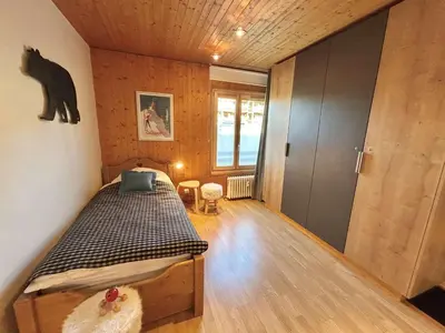 a bedroom with a bed and a bear on the wall at Appartement Megève 3 pièces, 4-6 personnes, parking - FR-1-597-195 in Megève