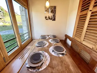 a dining room table with plates and glasses on it at Appartement Megève 3 pièces, 4-6 personnes, parking - FR-1-597-195 in Megève