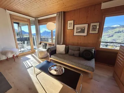 a living room with a couch and a table at Appartement Megève 3 pièces, 4-6 personnes, parking - FR-1-597-195 in Megève