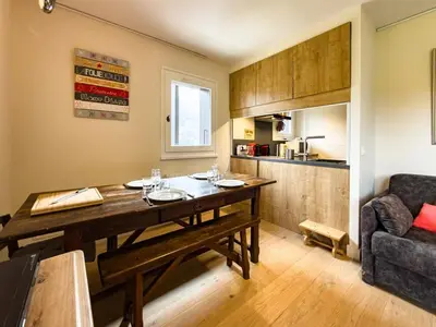 a dining room with a table and a couch at Les Cimes de Saint-Gervais apartment in Saint-Gervais-les-Bains