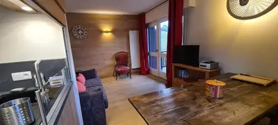 a living room with a couch and a table at Les Cimes de Saint-Gervais apartment in Saint-Gervais-les-Bains