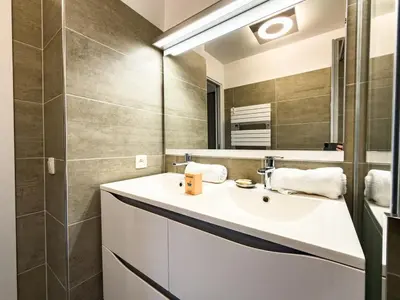 a bathroom with a sink and a mirror at Les Cimes de Saint-Gervais apartment in Saint-Gervais-les-Bains