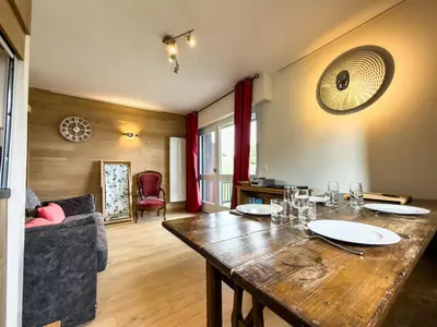 a dining room with a wooden table in a room at Les Cimes de Saint-Gervais apartment in Saint-Gervais-les-Bains