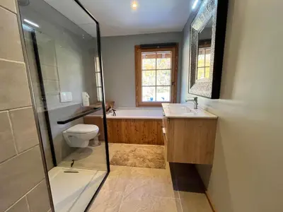 a bathroom with a tub and a toilet and a sink at Chalet rénové à Samoëns, proche centre, skis-bus - FR-1-624-186 in Samoëns