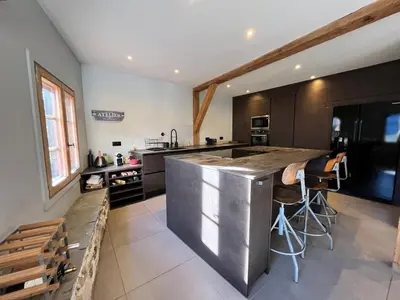 a kitchen with a large stainless steel counter top at Chalet rénové à Samoëns, proche centre, skis-bus - FR-1-624-186 in Samoëns