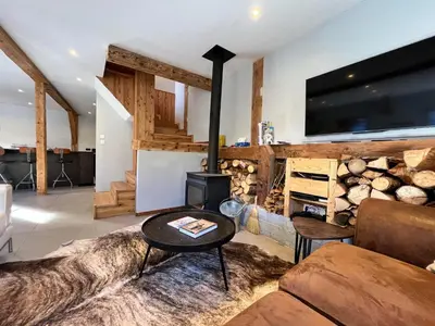 a living room with a couch and a fire place at Chalet rénové à Samoëns, proche centre, skis-bus - FR-1-624-186 in Samoëns