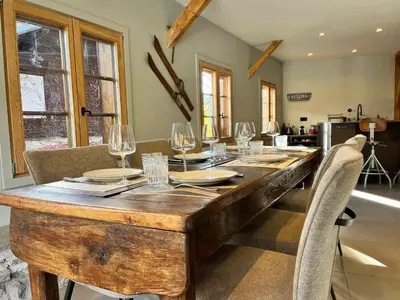 a wooden table with wine glasses on top of it at Chalet rénové à Samoëns, proche centre, skis-bus - FR-1-624-186 in Samoëns