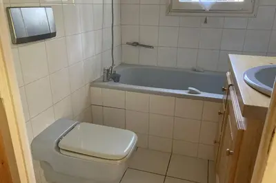 a bathroom with a tub and a toilet and a sink at Stay Mountain with View and Optimal Comfort in Megève