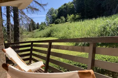 a couple of chairs sitting on a balcony at Stay Mountain with View and Optimal Comfort in Megève