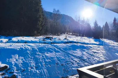 a river covered in snow with the sun in the background at Stay Mountain with View and Optimal Comfort in Megève