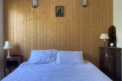 a bedroom with a bed with blue sheets and two lamps at Stay Mountain with View and Optimal Comfort in Megève