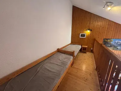 a room with two beds and a balcony at Charmant T2 Mezzanine au centre - Animaux acceptés - FR-1-624-187 in Samoëns