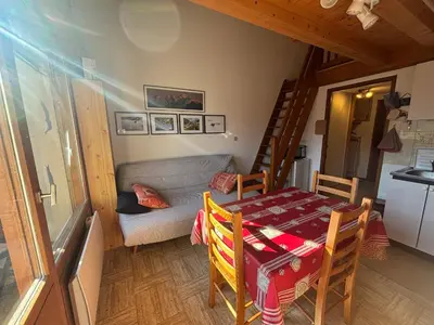 a living room with a table and a couch at Charmant T2 Mezzanine au centre - Animaux acceptés - FR-1-624-187 in Samoëns