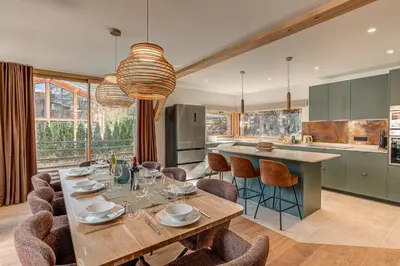 a kitchen with a table and chairs and a kitchen with a counter at Chalet Diard, Detached Chalet, Alpes Travel, Sleeps 6 to 8 in Chamonix-Mont-Blanc