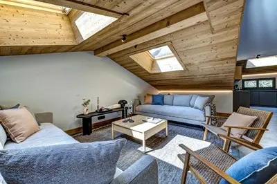 a living room with two couches and a table at Chalet du Cristal Blanc in Chamonix-Mont-Blanc