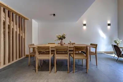 a dining room with a wooden table and chairs at Chalet du Cristal Blanc in Chamonix-Mont-Blanc