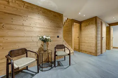 a room with two chairs and a table and a vase with flowers at Chalet du Cristal Blanc in Chamonix-Mont-Blanc
