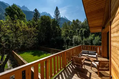 a deck with benches and a view of the mountains at Chalet du Cristal Blanc in Chamonix-Mont-Blanc