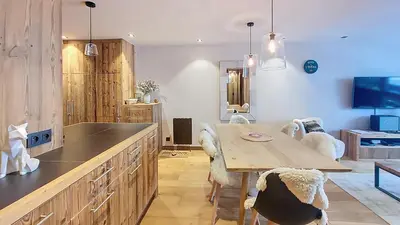 a bedroom with a bed with a sink and a mirror at Appartement Haut de gamme- Rochebrune aux pieds des pistes- 3 chambres in Megève