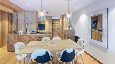 a dining room with a wooden table and chairs at Appartement Haut de gamme- Rochebrune aux pieds des pistes- 3 chambres in Megève
