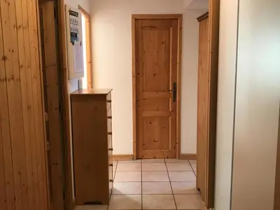 a hallway with a door and a refrigerator in a room at Appartement 3 pièces - 6 pers. - Pied de piste avec garage - FR-1-836-14 in Arâches-la-Frasse