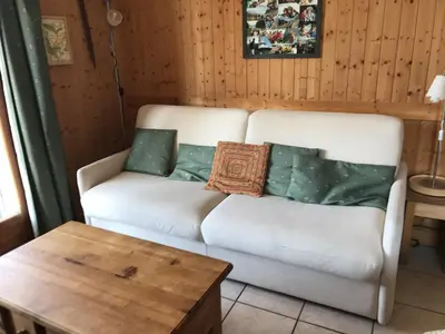 a living room with a white couch and a table at Appartement 3 pièces - 6 pers. - Pied de piste avec garage - FR-1-836-14 in Arâches-la-Frasse