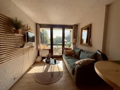 a living room with a couch and a table at Studio cosy rénové avec balcon sud - 2 pers. - FR-1-836-15 in Arâches-la-Frasse