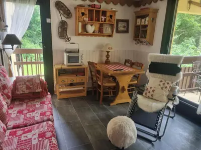 a living room with a couch and a table with a microwave at Charmant T2 à Arâches-la-Frasse, pour 4 personnes - FR-1-836-19 in Arâches-la-Frasse