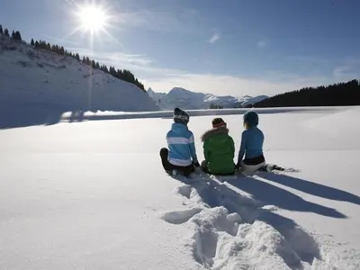 a group of three people sitting in the snow at Charmant T2 à Arâches-la-Frasse, pour 4 personnes - FR-1-836-19 in Arâches-la-Frasse