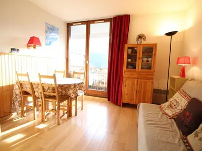 a living room with a table and a couch at Studio 4 pers avec balcon au pied des pistes - FR-1-687-117 in Arâches-la-Frasse