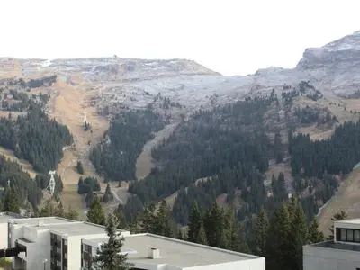 a view of a mountain with trees and a building at Studio 4 pers avec balcon au pied des pistes - FR-1-687-117 in Arâches-la-Frasse