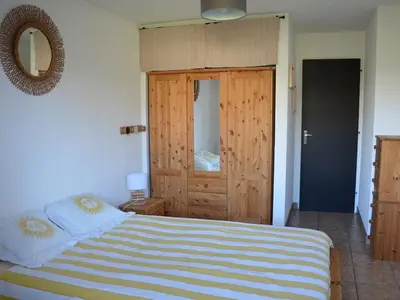 a bedroom with a bed and a wooden door at Charmant 2 pièces avec WIFI et 4 couchages à Le Pernant - FR-1-836-16 in Arâches-la-Frasse