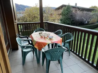 a table and chairs on a balcony with a view at Appart spacieux 6 pers Samoëns avec animaux admis - FR-1-629-151 in Samoëns