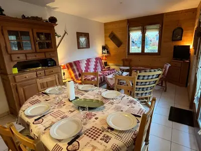 a dining room with a table with plates on it at Appart spacieux 6 pers Samoëns avec animaux admis - FR-1-629-151 in Samoëns