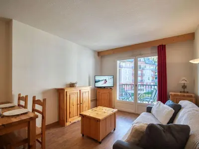 a living room with a couch and a tv at Appartement cosy à Saint-Gervais, proche télécabine, parking inclus - FR-1-663-57 in Saint-Gervais-les-Bains