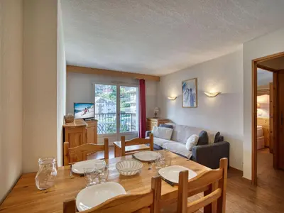 a living room with a table and chairs and a couch at Appartement cosy à Saint-Gervais, proche télécabine, parking inclus - FR-1-663-57 in Saint-Gervais-les-Bains