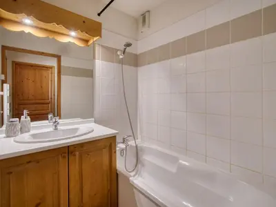 a bathroom with a sink and a bath tub at Appartement cosy à Saint-Gervais, proche télécabine, parking inclus - FR-1-663-57 in Saint-Gervais-les-Bains