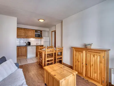a kitchen with wooden cabinets and a table in a room at Appartement cosy à Saint-Gervais, proche télécabine, parking inclus - FR-1-663-57 in Saint-Gervais-les-Bains