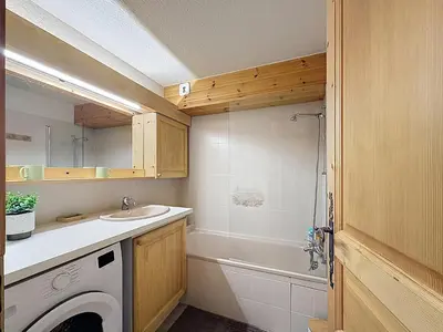 a bathroom with a sink and a washing machine at Appartement cosy avec balcon près du centre de Combloux - FR-1-560-170 in Combloux