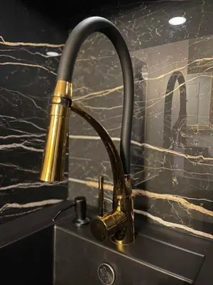a kitchen sink with a brass faucet on a counter at Central Chamonix, Charming Studio & Balcony in Chamonix-Mont-Blanc