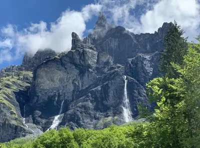 a waterfall on the side of a mountain at Central Chamonix, Charming Studio & Balcony in Chamonix-Mont-Blanc