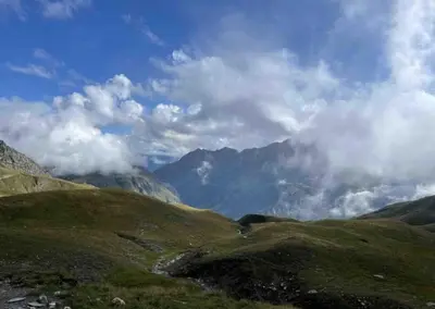 a view of a mountain range with clouds in the sky at Central Chamonix, Charming Studio & Balcony in Chamonix-Mont-Blanc