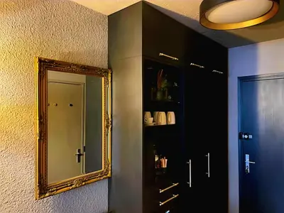 a mirror on a wall next to a door at Central Chamonix, Charming Studio & Balcony in Chamonix-Mont-Blanc