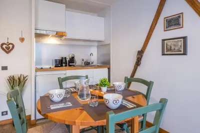 a living room with a table and a dining room at Near the slopes of Chamonix-Mont-Blanc - Balcony in Chamonix-Mont-Blanc