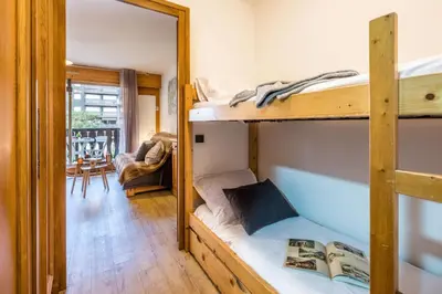 a living room with a couch and a table at Near the slopes of Chamonix-Mont-Blanc - Balcony in Chamonix-Mont-Blanc