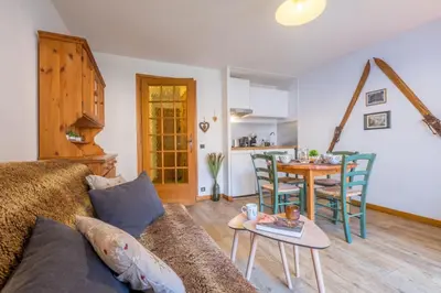 a living room with a couch and a table at Near the slopes of Chamonix-Mont-Blanc - Balcony in Chamonix-Mont-Blanc