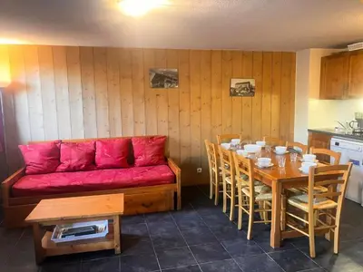 a living room with a red couch and a table at Résidence Les Arolles - Bat Melezes - LES MELEZES - C332 MAE-3363 in Saint-Gervais-les-Bains