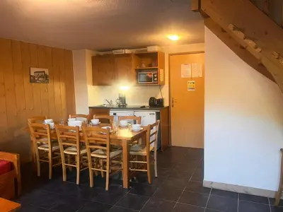 a kitchen with a dining room table and chairs at Résidence Les Arolles - Bat Melezes - LES MELEZES - C332 MAE-3363 in Saint-Gervais-les-Bains