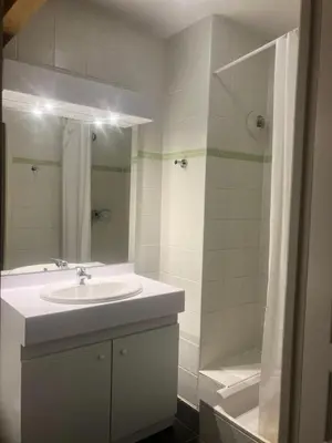 a white bathroom with a sink and a shower at Résidence Les Arolles - Bat Melezes - LES MELEZES - C332 MAE-3363 in Saint-Gervais-les-Bains