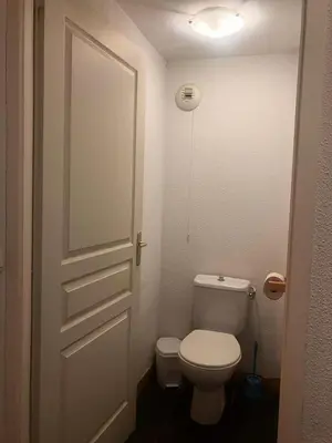 a bathroom with a white toilet and a door at Résidence Les Arolles - Bat Melezes - LES MELEZES - C332 MAE-3363 in Saint-Gervais-les-Bains